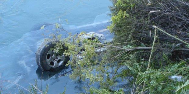 A driver escaped drowning after their car landed upside-down in a river. Photo / APNZ A driver escaped drowning after their car landed upside-down in a river. Photo / APNZ