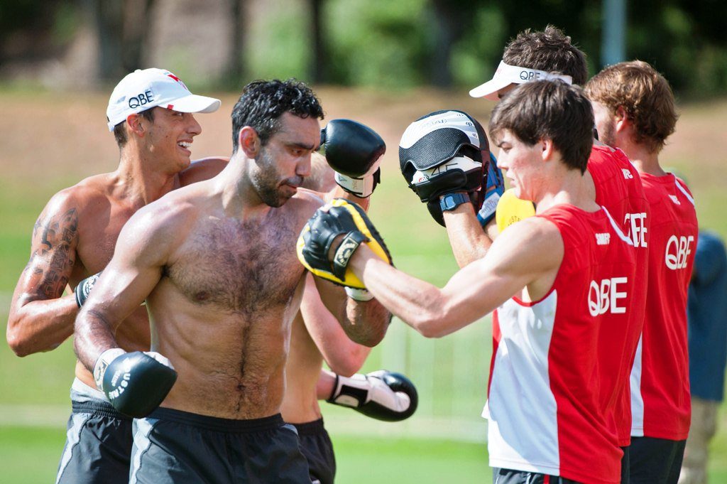 Dual Brownlow medalist, two-time premiership player and now Australian of the Year Adam Goodes works hard on the boxing pads while his Sydney Swans teammates sweat it out in an intra-club practice match at C.ex Coffs International Stadium. Photo: Rob Wright / The Coffs Coast Advocate Dual Brownlow medalist, two-time premiership player and now Australian of the Year Adam Goodes works hard on the boxing pads while his Sydney Swans teammates sweat it out in an intra-club practice match at C.ex Coffs International Stadium. Photo: Rob Wright / The Coffs Coast Advocate