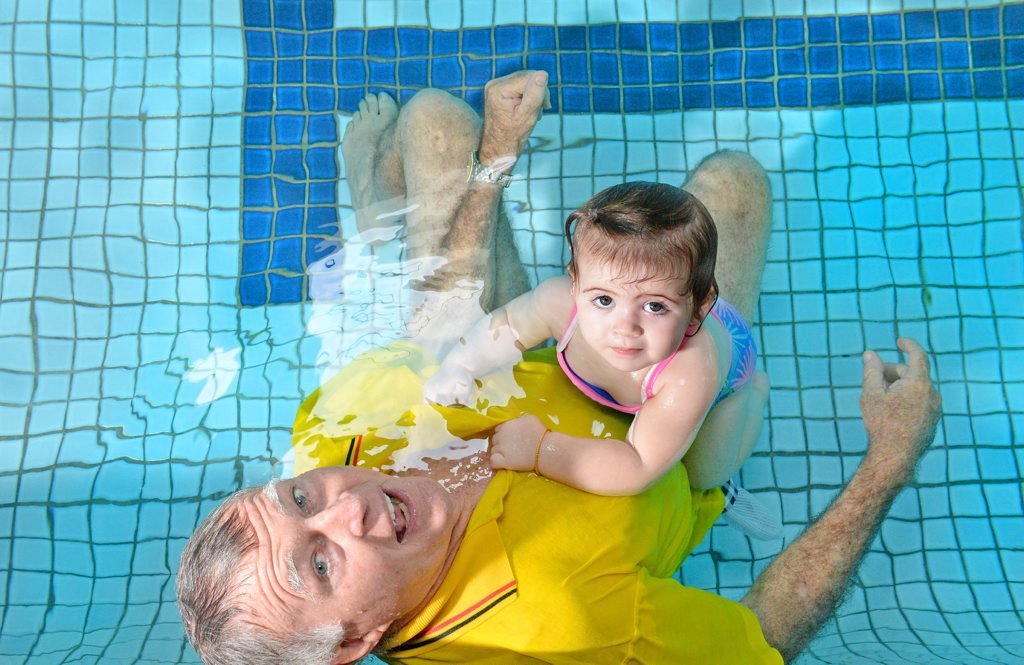 Image for sale: Laurie Lawrence and his grandaughter Harper Reid in the pool at his Banora swim school.