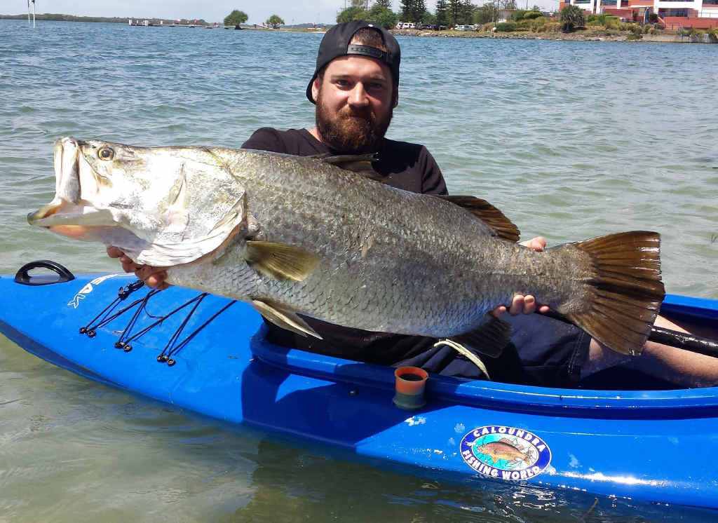 HOOKED ON LIFE: Matt Gibbs and the big barra he reeled in from his little canoe. HOOKED ON LIFE: Matt Gibbs and the big barra he reeled in from his little canoe.