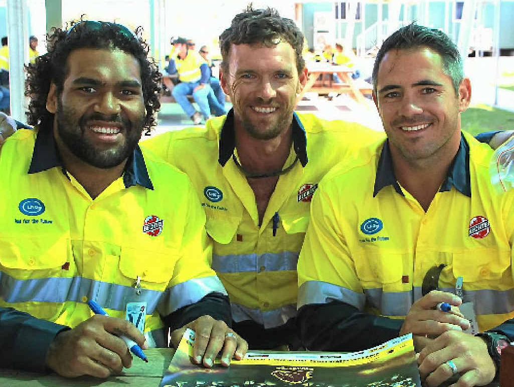 League fan Ewan Hetherington with Brisbane Broncos players Sam Thaiday (left) and Corey Parker at the GLNG site on Curtis Island. League fan Ewan Hetherington with Brisbane Broncos players Sam Thaiday (left) and Corey Parker at the GLNG site on Curtis Island.