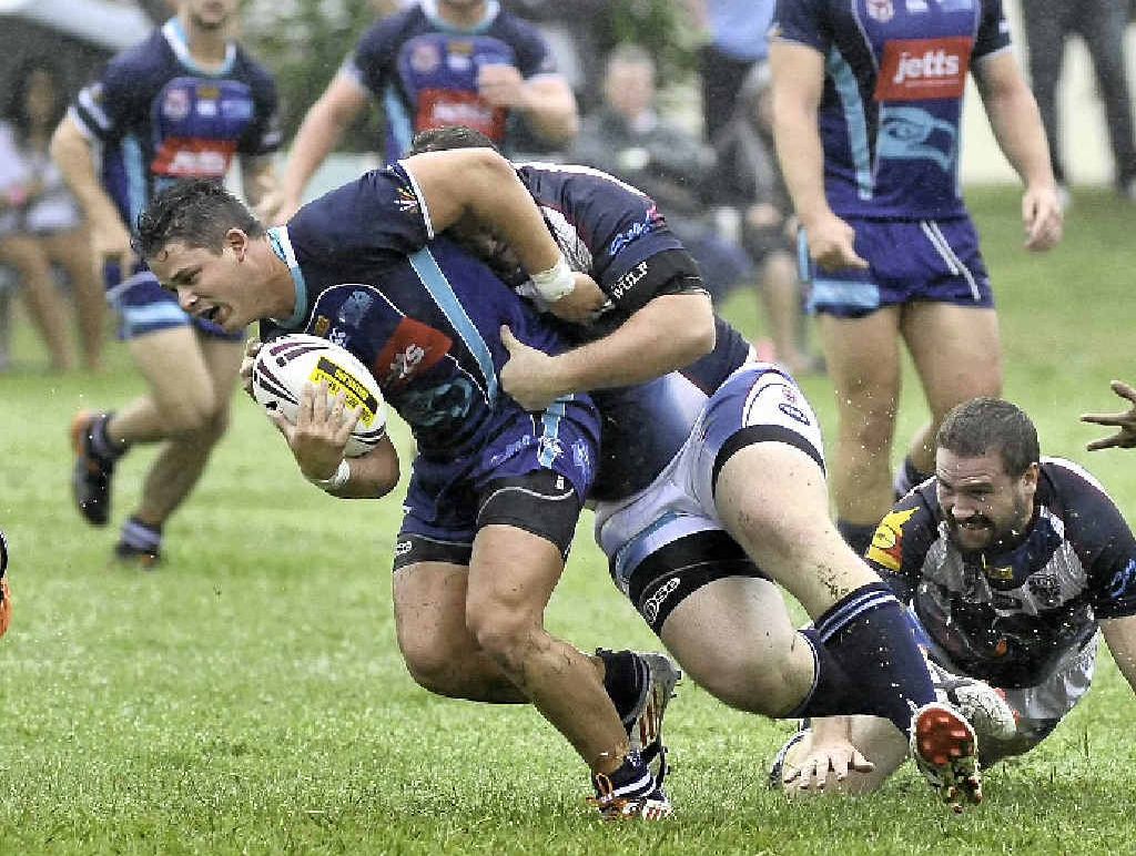Falcons’ Brett Doherty is wrapped up by the CQ defence. Falcons’ Brett Doherty is wrapped up by the CQ defence.
