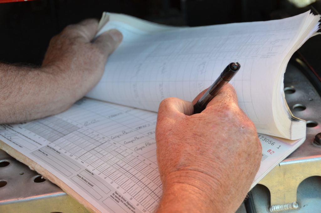 Truck driver fills out a log book Photo Carly Morrissey / Big Rigs Truck driver fills out a log book Photo Carly Morrissey / Big Rigs