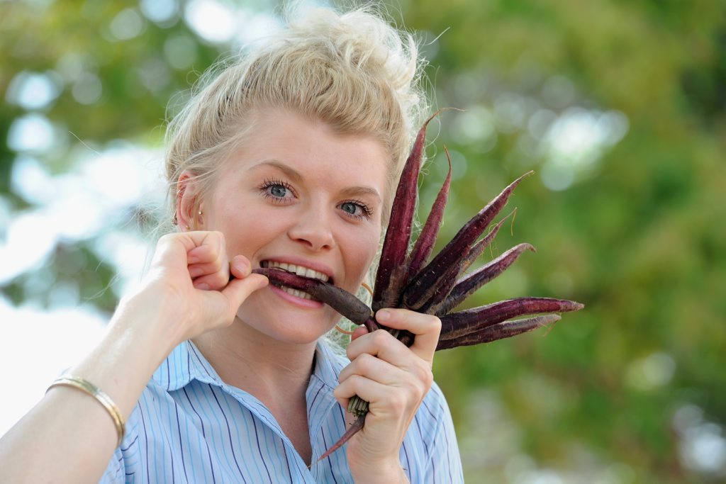 Taylor Osmond, 22, with a bunch of purple carrots that research has shown is great for health and for losing weight. Taylor Osmond, 22, with a bunch of purple carrots that research has shown is great for health and for losing weight.