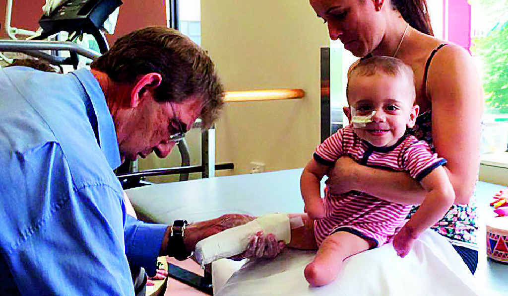 Tiny tot Finn Smith still manages a smile as he gets his new “legs” sized up yesterday. Tiny tot Finn Smith still manages a smile as he gets his new “legs” sized up yesterday.