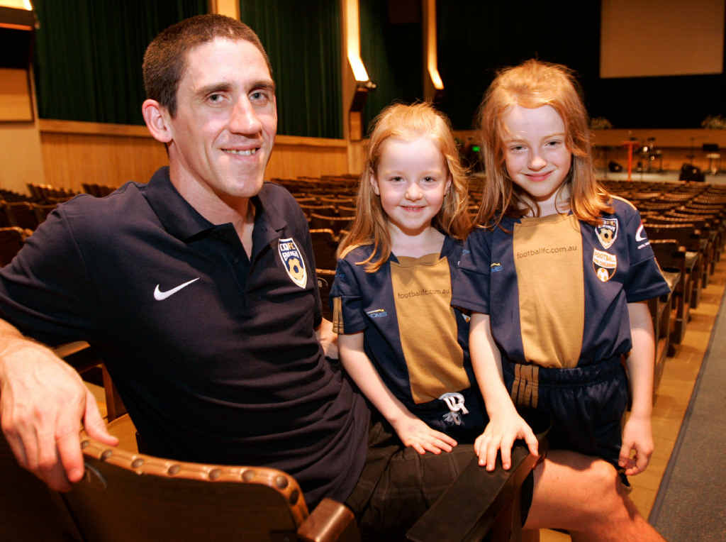 CQFC goalkeeper and St Andrew’s Presbyterian Church assistant pastor Andrew Poyser with his daughters Abby, 5, and Charlotte, 7, at the church. He’s in goal for CQFC on Saturday night in their friendly against Southside United. CQFC goalkeeper and St Andrew’s Presbyterian Church assistant pastor Andrew Poyser with his daughters Abby, 5, and Charlotte, 7, at the church. He’s in goal for CQFC on Saturday night in their friendly against Southside United.