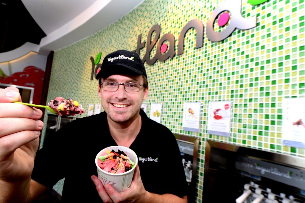 Rockhampton Yogurtland store manager Chris Allen makes a yoghurt creation. Photo Sharyn O'Neill / The Morning Bulletin Rockhampton Yogurtland store manager Chris Allen makes a yoghurt creation. Photo Sharyn O'Neill / The Morning Bulletin
