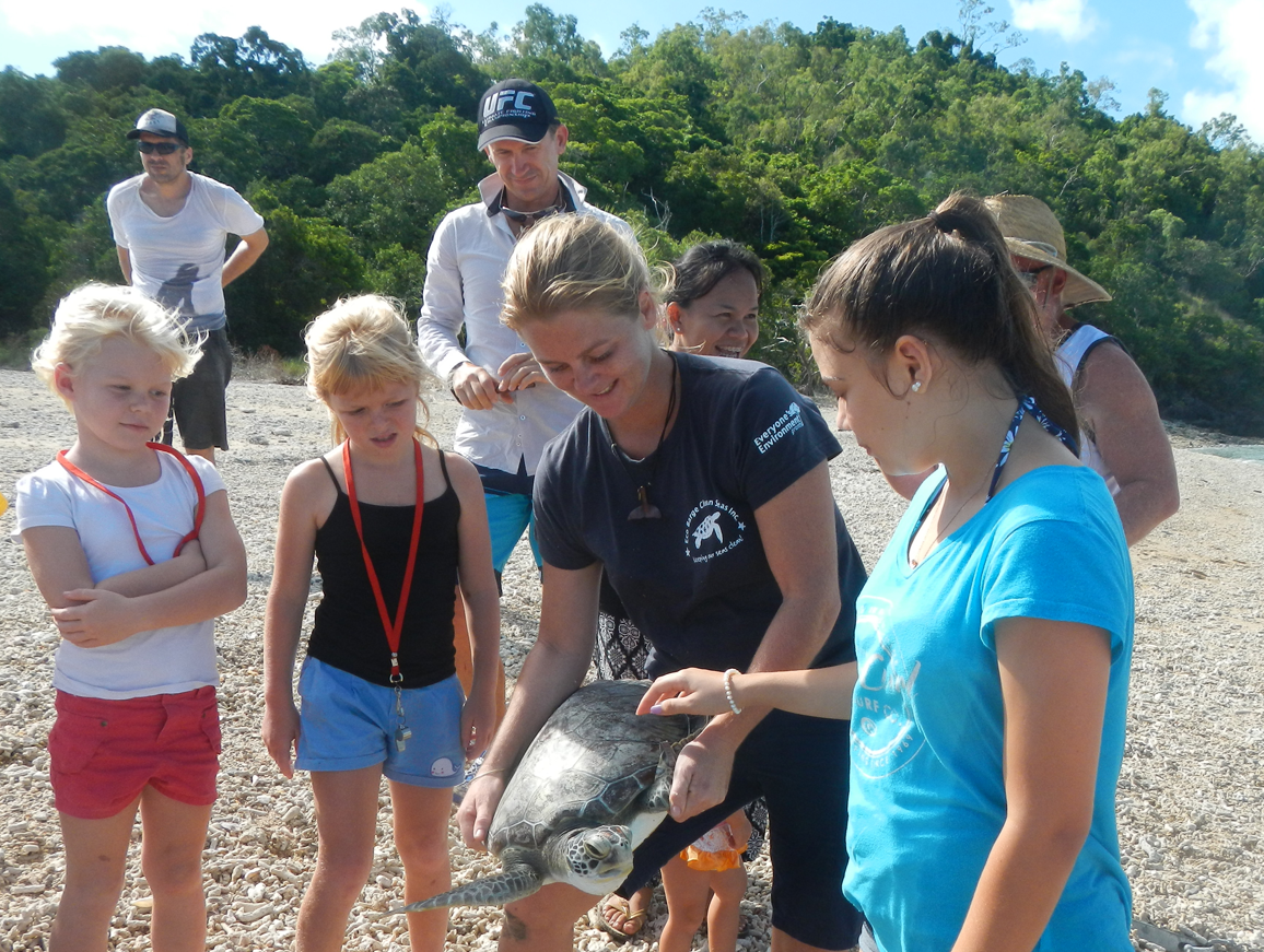 RELEASED: Sheridan Clegg, Brett Allan, Luck Saisang and Bill Edge (back) and Billie Edge, Hayley Edge, Libby Edge and Krishna Garland (front), releasing a green sea turtle back into the wild on Sunday, February 16.