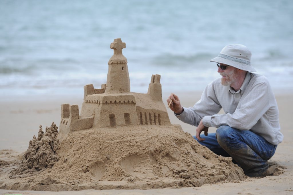 Mike Lewis from Oregon working on one of his sandcastle masterpieces on Shelly Beach. Mike Lewis from Oregon working on one of his sandcastle masterpieces on Shelly Beach.