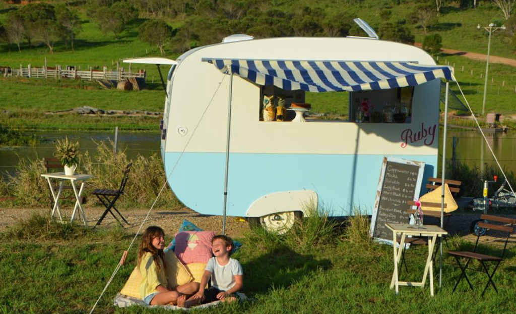 VINTAGE COFFEE: Sophia Willson and Roman Willson enjoy a laugh together as they relax in front of their mum’s (Rachael Willson) new business Ruby Caravan. (Inset) Owner Rachael Willson busy making coffee. VINTAGE COFFEE: Sophia Willson and Roman Willson enjoy a laugh together as they relax in front of their mum’s (Rachael Willson) new business Ruby Caravan. (Inset) Owner Rachael Willson busy making coffee.