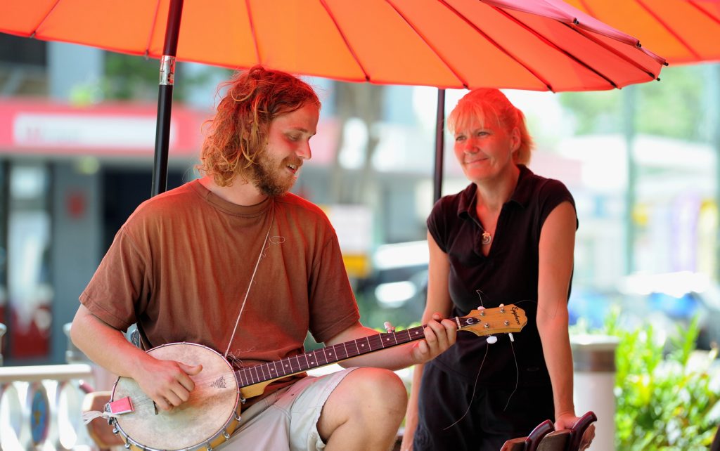 Eliza's cafe owner Stacy Gleich was happy for Canadian busker Robert McLaren to play outside her cafe. 