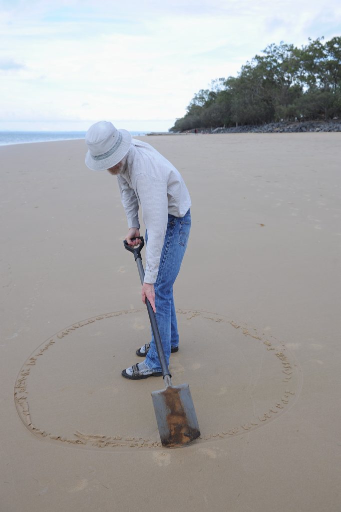 Mike Lewis marks out the beach for his next sandcastle. Photo: Alistair Brightman / Fraser Coast Chronicle