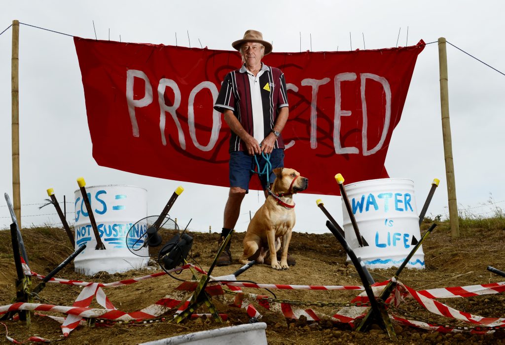 A protester stands in protest against CSG mining in Bentley. A protester stands in protest against CSG mining in Bentley.