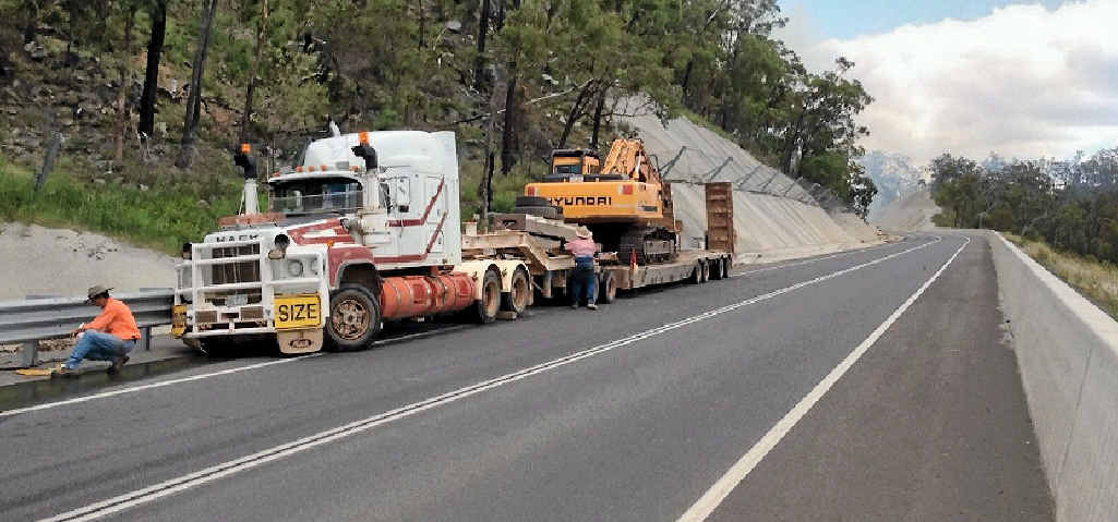 The wayward truck and trailer unit comes to rest against the guardrail on the wrong side of the Dawson Hwy. The wayward truck and trailer unit comes to rest against the guardrail on the wrong side of the Dawson Hwy.