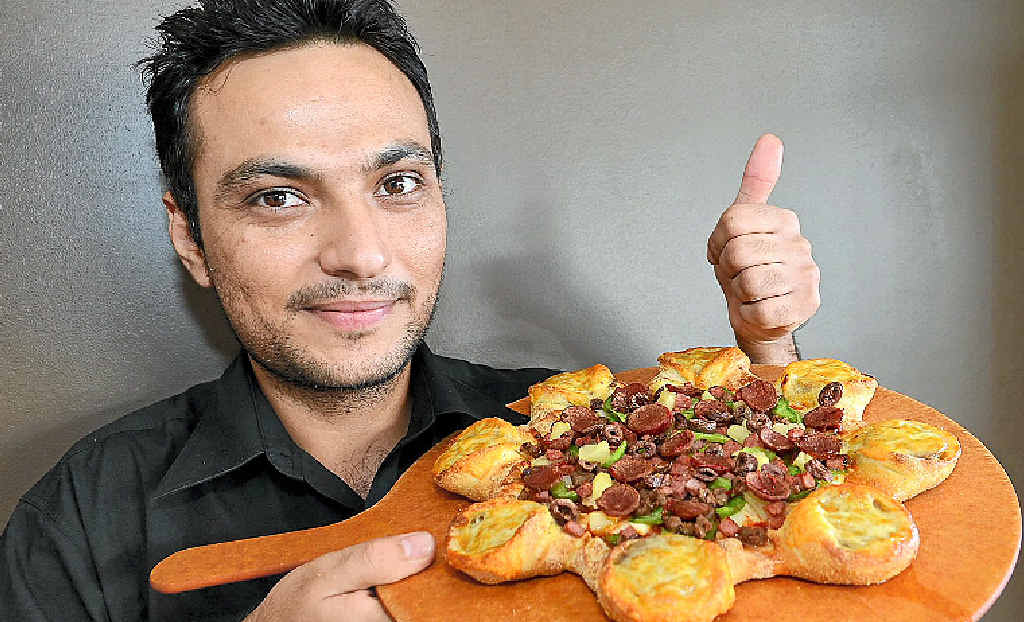 DIVIDING OPINION: Pizza Hut store manager Sonu Hayer with the new cheeseburger pizza. DIVIDING OPINION: Pizza Hut store manager Sonu Hayer with the new cheeseburger pizza.