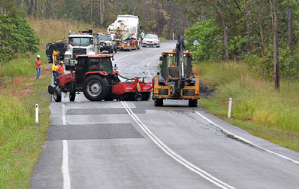 Crews work to clear wreckage from the Peak Downs Highway after the fatal crash at Stockyard Creek on Saturday night. Crews work to clear wreckage from the Peak Downs Highway after the fatal crash at Stockyard Creek on Saturday night.
