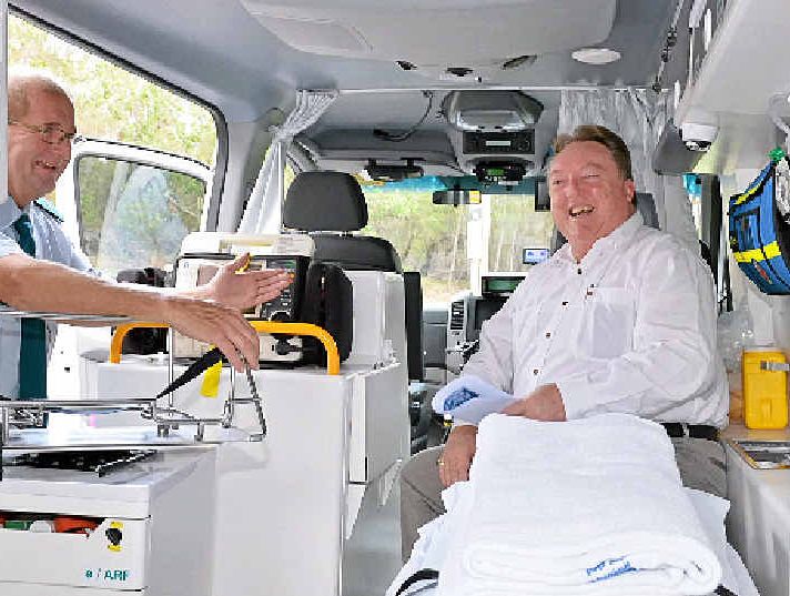 TOP EQUIPMENT: Local MP Glen Elmes prepares to present a new ambulance to Noosa Heads ambulance duty officer Ashleigh Westerman.