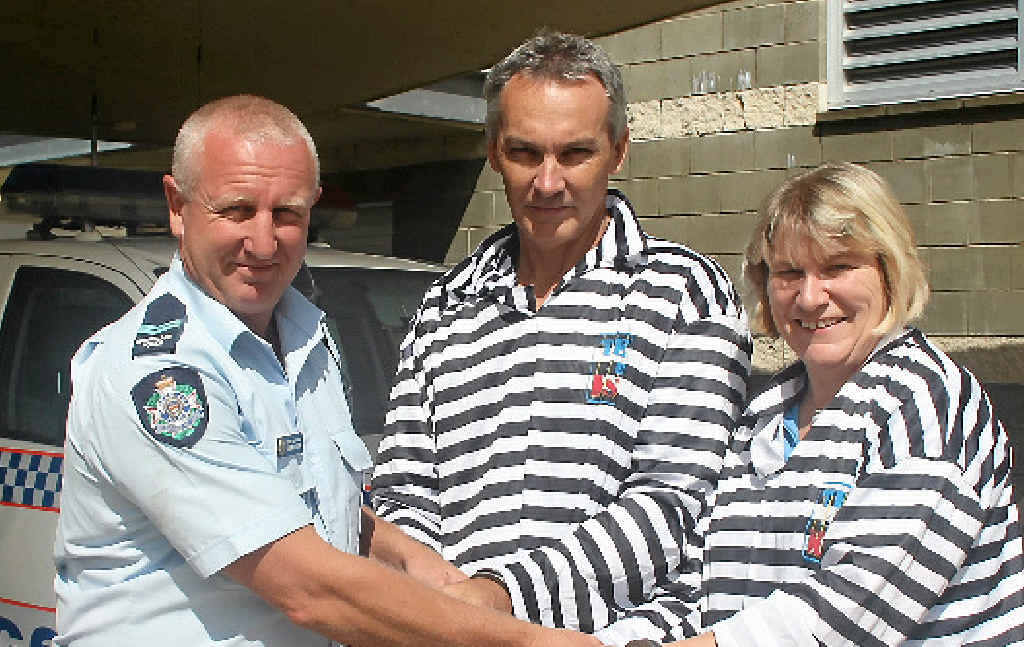 LOCKED UP: Whitsunday business people Craig Spence and Leanne Abernethy were locked up by Whitsunday Police Station senior constable Simon Docking during last year’s charity fundraiser Time for Kids.