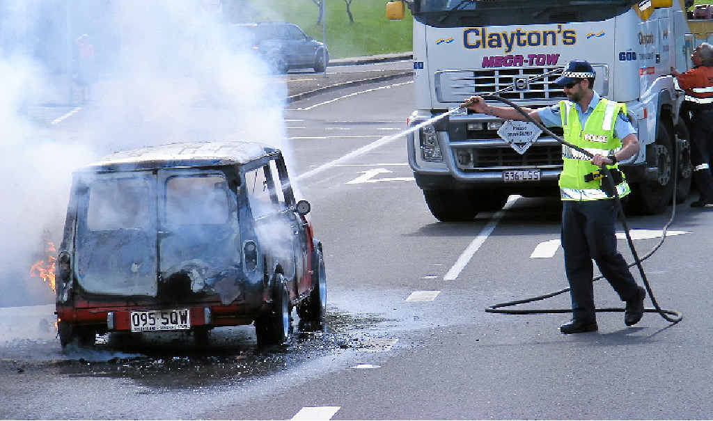 RESTORATION RUINED: A police officer helps hose a burning 1978 Leyland Mini station wagon. The rare car, which was being restored, caught fire on Buderim-Mooloolaba Rd last year. RESTORATION RUINED: A police officer helps hose a burning 1978 Leyland Mini station wagon. The rare car, which was being restored, caught fire on Buderim-Mooloolaba Rd last year.