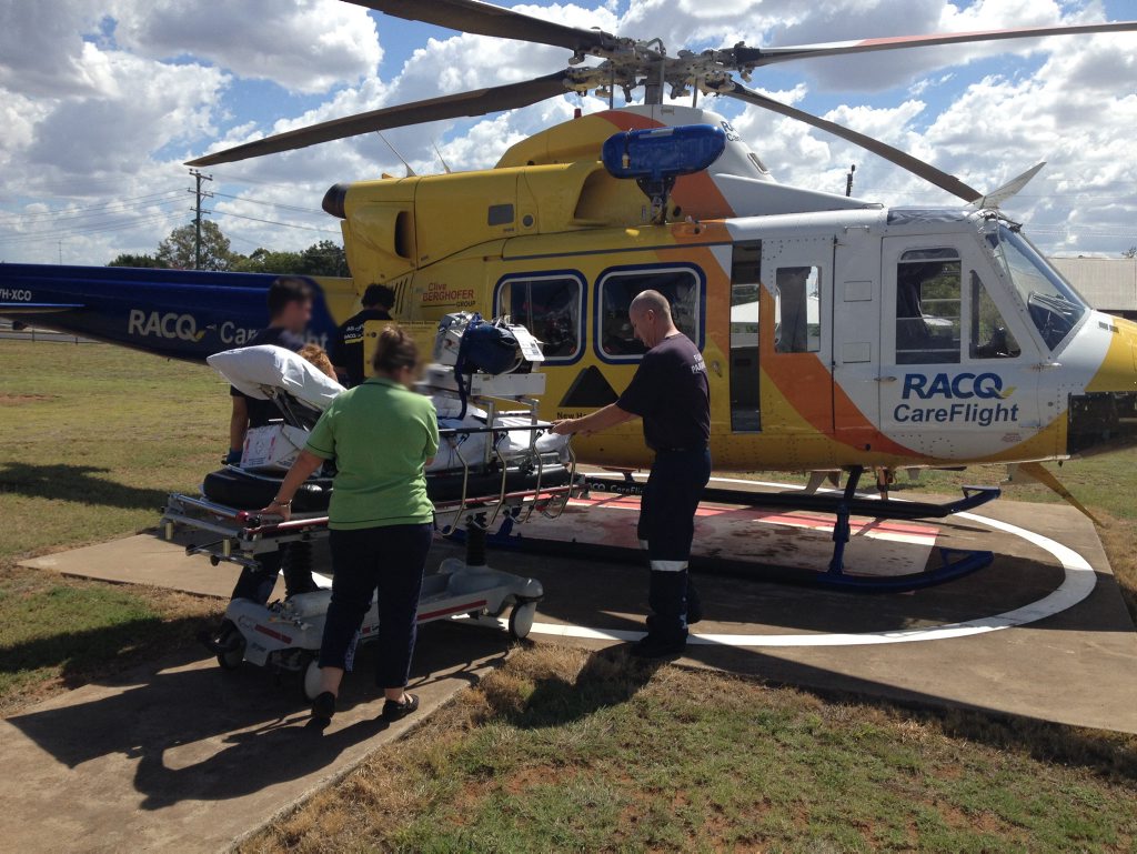 Careflight crew members load the boy into the helicopter. Careflight crew members load the boy into the helicopter.