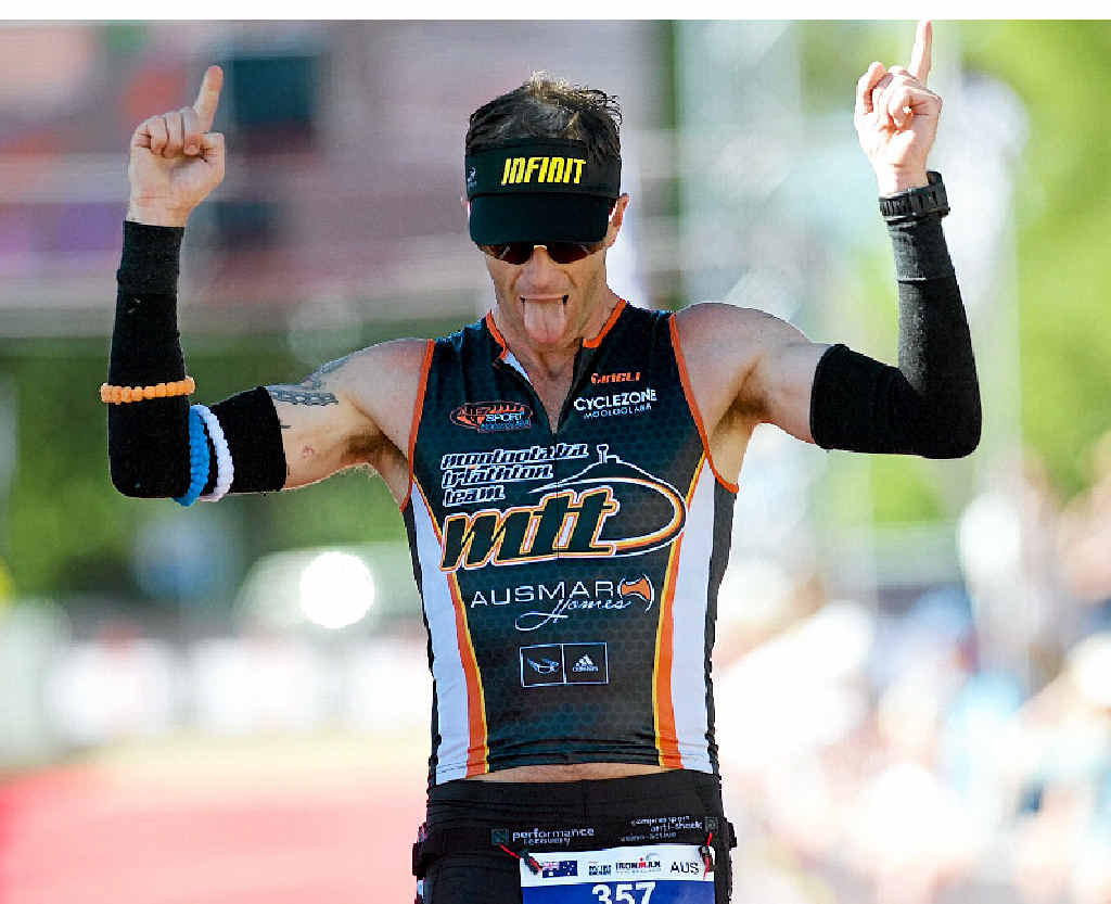 CELEBRATION TIME: Scott Farrell crosses the line at Ironman New Zealand. CELEBRATION TIME: Scott Farrell crosses the line at Ironman New Zealand.