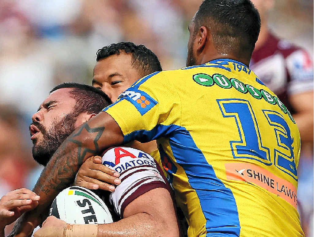SMASHED: Manly’s Justin Horo is tackled high by Kenny Edwards. SMASHED: Manly’s Justin Horo is tackled high by Kenny Edwards.