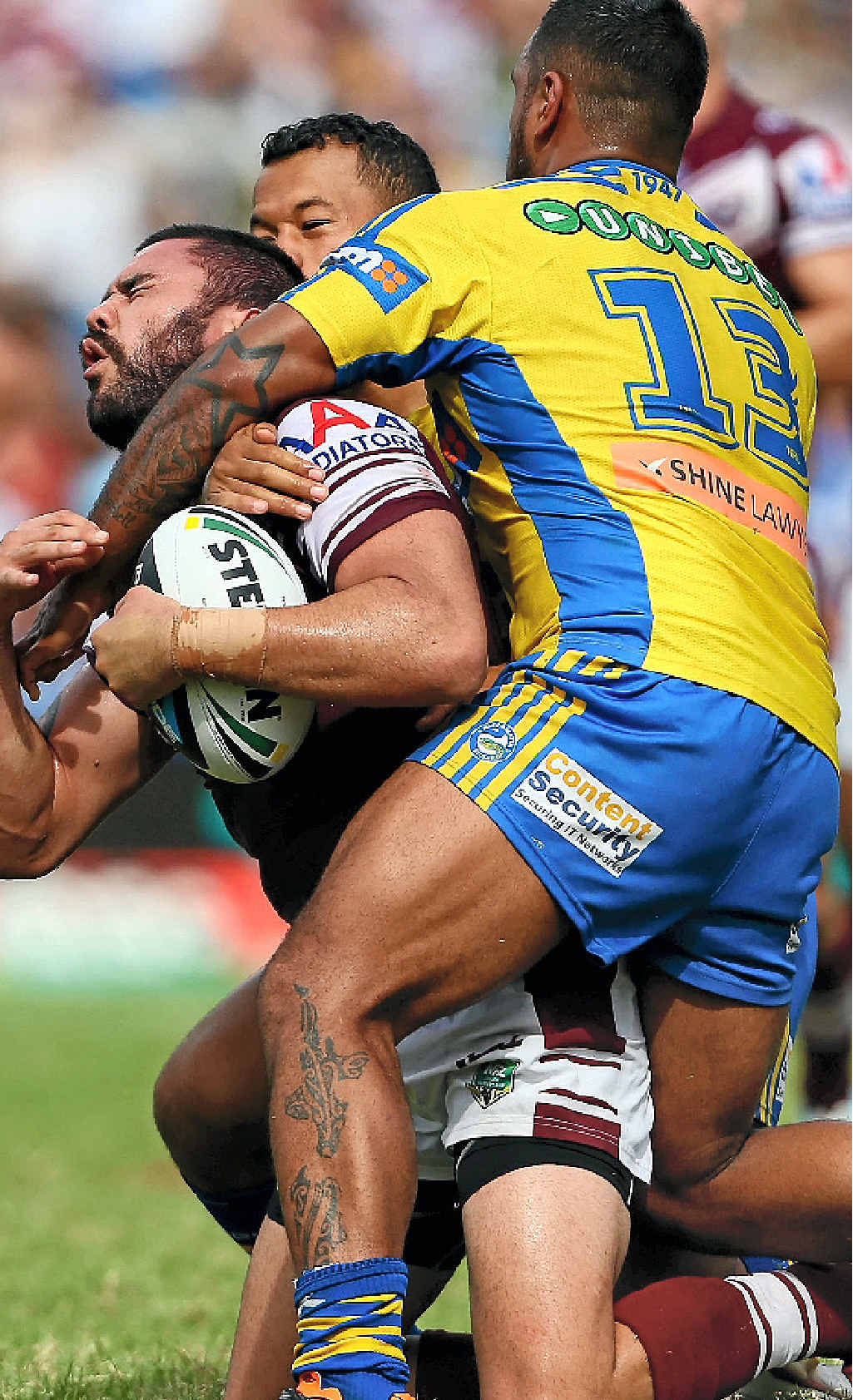 SMASHED: Manly’s Justin Horo is tackled high by Kenny Edwards. SMASHED: Manly’s Justin Horo is tackled high by Kenny Edwards.