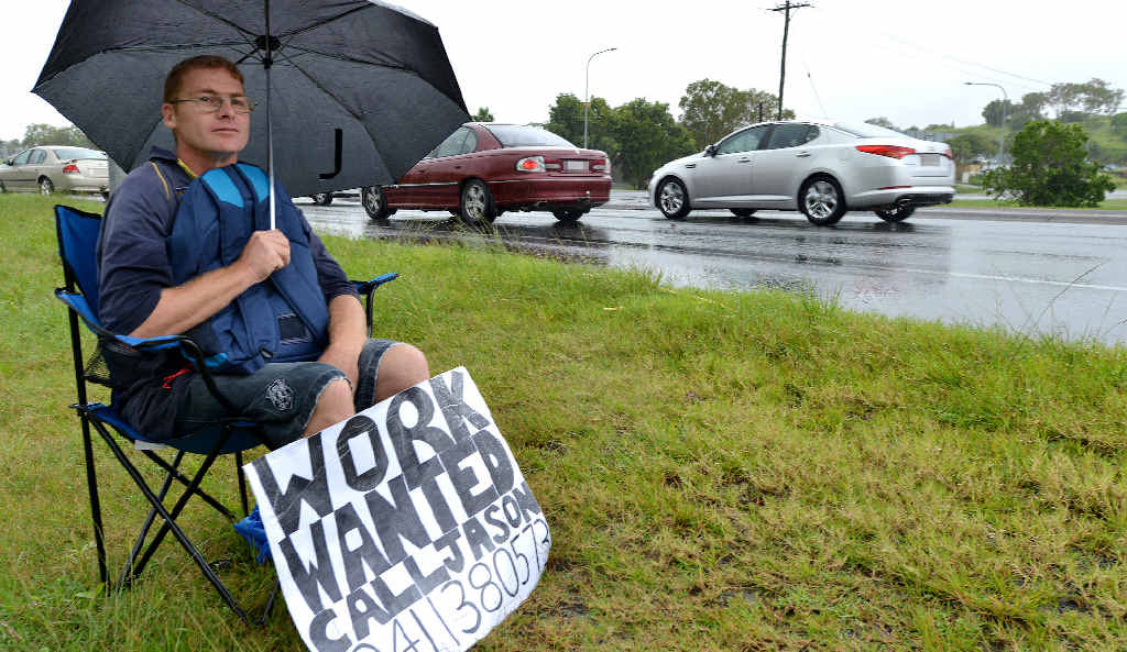 Jason Wheatley didn’t let heavy rain stop him as he sat on Mackay Bucasia Road at Mount Pleasant looking for work. Jason Wheatley didn’t let heavy rain stop him as he sat on Mackay Bucasia Road at Mount Pleasant looking for work.