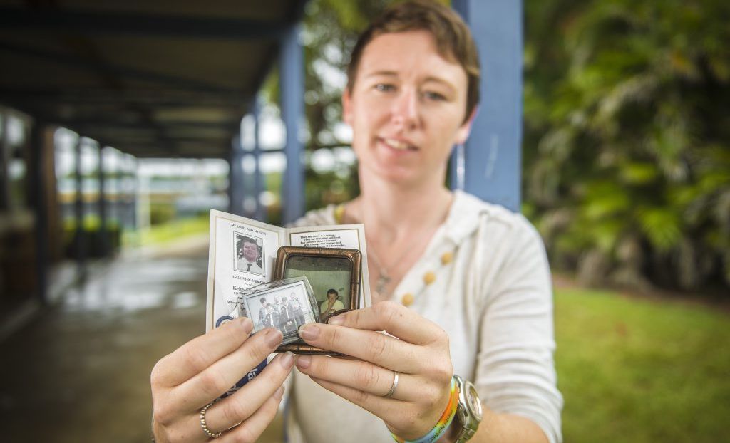 Niamh O'Sullivan holding images of her brother, Keith O'Sullivan, at Gladstone State High School, Gladstone. Niamh O'Sullivan holding images of her brother, Keith O'Sullivan, at Gladstone State High School, Gladstone.