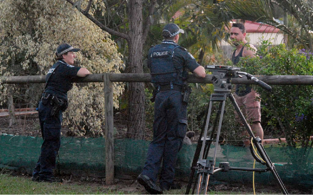 STUNNED BY DEATHS: Police chat to a neighbour at Allan Ave yesterday after discovering the dead couple. STUNNED BY DEATHS: Police chat to a neighbour at Allan Ave yesterday after discovering the dead couple.