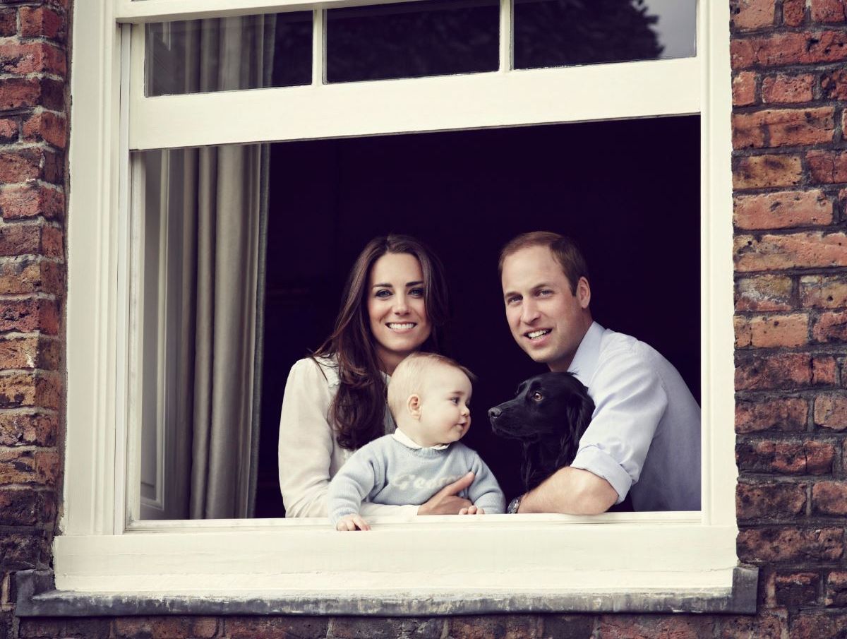 A picture made available on 29 March 2014 shows Catherine, Duchess of Cambridge (L) and Prince William, Duke of Cambridge (R) with their son Prince George (C) photographed at Kensington Palace