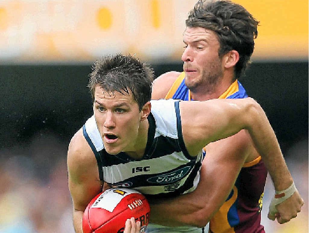 TOP CAT: Andrew Mackie is tackled by Rohan Bewick at the Gabba yesterday. TOP CAT: Andrew Mackie is tackled by Rohan Bewick at the Gabba yesterday.