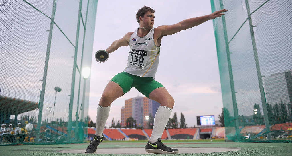 WINNER: Matthew Denny in action as he scores a World Youth Lead score and his Personal Best and winning him the gold medal in the boys’ discus throw final during Day 4 of the IAAF World Youth Championships in Ukraine and (INSET) at home during a training session. WINNER: Matthew Denny in action as he scores a World Youth Lead score and his Personal Best and winning him the gold medal in the boys’ discus throw final during Day 4 of the IAAF World Youth Championships in Ukraine and (INSET) at home during a training session.