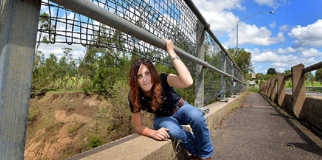 DANGEROUS: Lara Webster on the damaged Kidd Bridge yesterday morning before hastey council repairs eliminated the danger to pedestrians. DANGEROUS: Lara Webster on the damaged Kidd Bridge yesterday morning before hastey council repairs eliminated the danger to pedestrians.