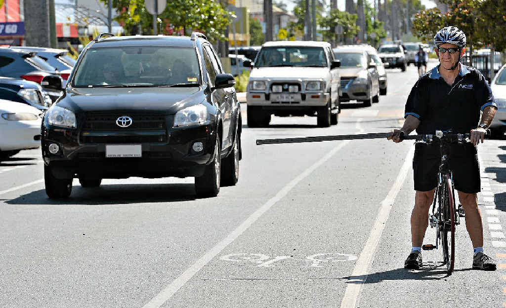 Rock N Road Cycles owner Ron Steel, a keen cyclist, demonstrates the one-metre rule from inside a cycling lane. Rock N Road Cycles owner Ron Steel, a keen cyclist, demonstrates the one-metre rule from inside a cycling lane.