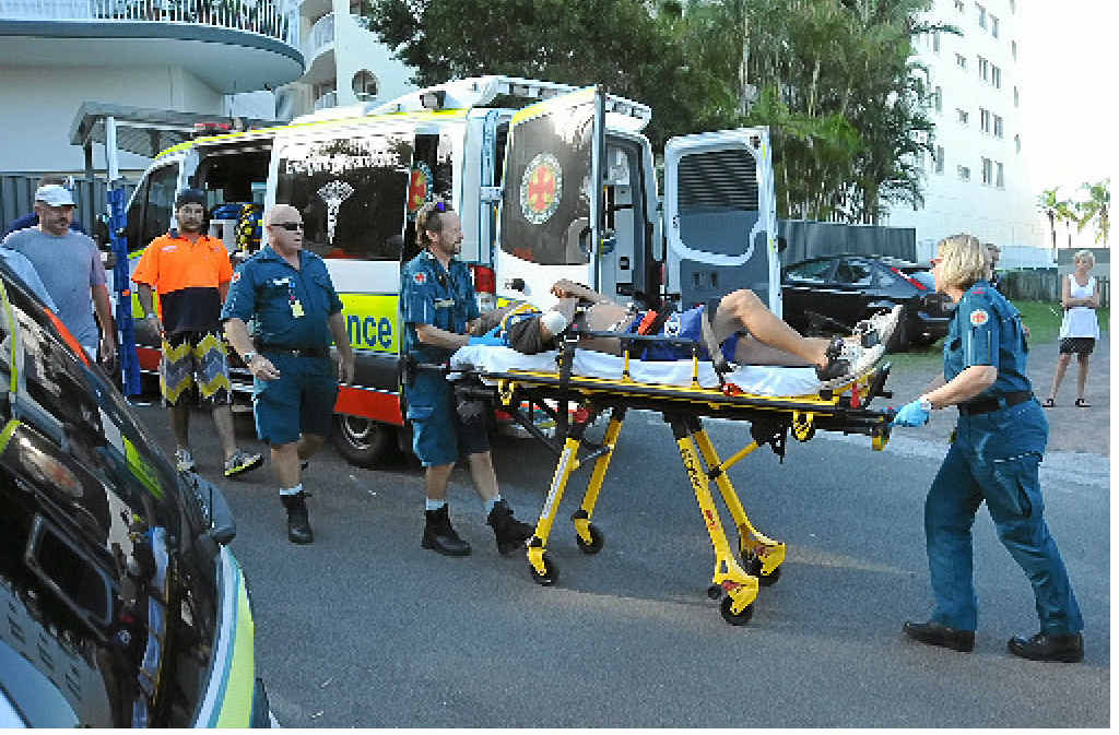 AMAZING ESCAPE: Paramedics stretcher the victim to a waiting ambulance. AMAZING ESCAPE: Paramedics stretcher the victim to a waiting ambulance.
