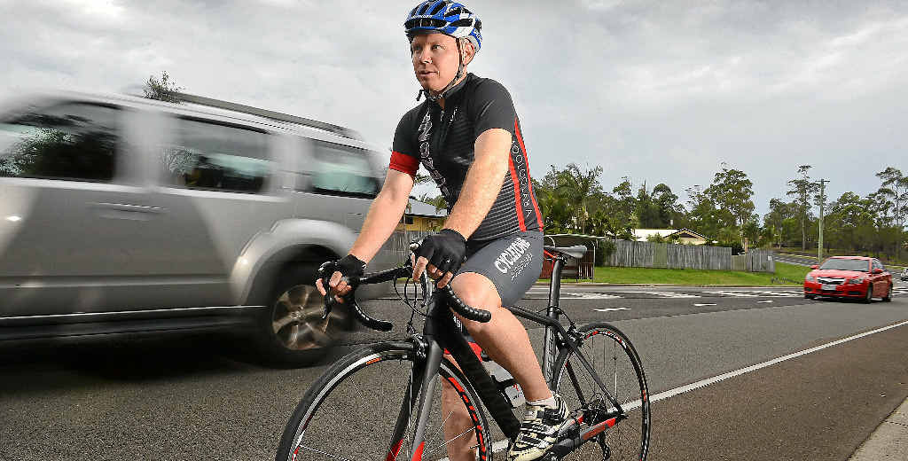 DANGER AHEAD: The new one-metre clearance law is tipped to cause fatalities. Cyclist Brett Reedman tackles a busy road. DANGER AHEAD: The new one-metre clearance law is tipped to cause fatalities. Cyclist Brett Reedman tackles a busy road.