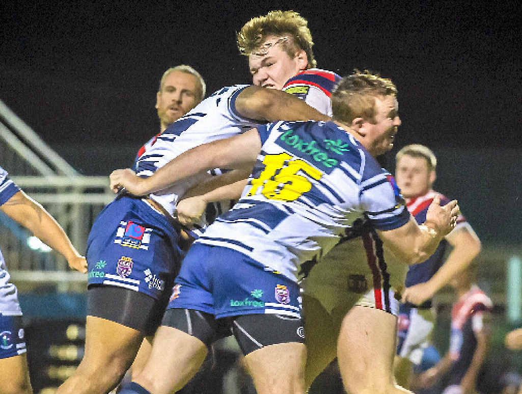 Roosters’ Matty Lewis hits the ball up against the Brothers. Roosters’ Matty Lewis hits the ball up against the Brothers.
