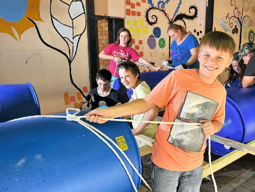 RAFT RIDE: Blake Denniss, 12, (front) at the helm of the raft being built for National Youth Week by (from left) Olivia Mison, 12, Matthew Gilliand, 14, Ebony Fallon, 15, Desirae Gilliand, 12, Jordan Gilliand, 13, and Flynn Geddes, 12. RAFT RIDE: Blake Denniss, 12, (front) at the helm of the raft being built for National Youth Week by (from left) Olivia Mison, 12, Matthew Gilliand, 14, Ebony Fallon, 15, Desirae Gilliand, 12, Jordan Gilliand, 13, and Flynn Geddes, 12.