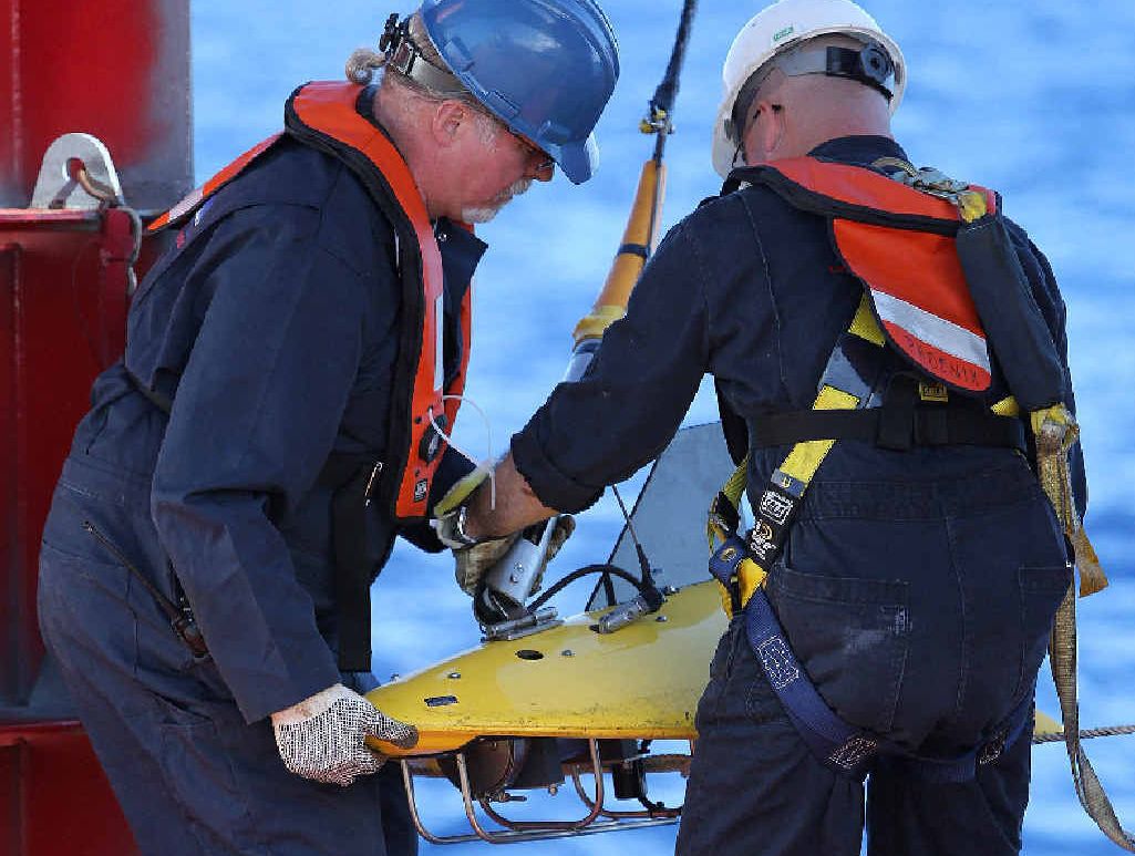 Phoenix International personnel, Mike Unzicker (L) and Chris Minor deploy the towed pinger locator off the deck of Australian Defence Vessel Ocean Shield in the first search for the missing flight data recorder and cockpit voice recorder, in the Indian Ocean. Phoenix International personnel, Mike Unzicker (L) and Chris Minor deploy the towed pinger locator off the deck of Australian Defence Vessel Ocean Shield in the first search for the missing flight data recorder and cockpit voice recorder, in the Indian Ocean.