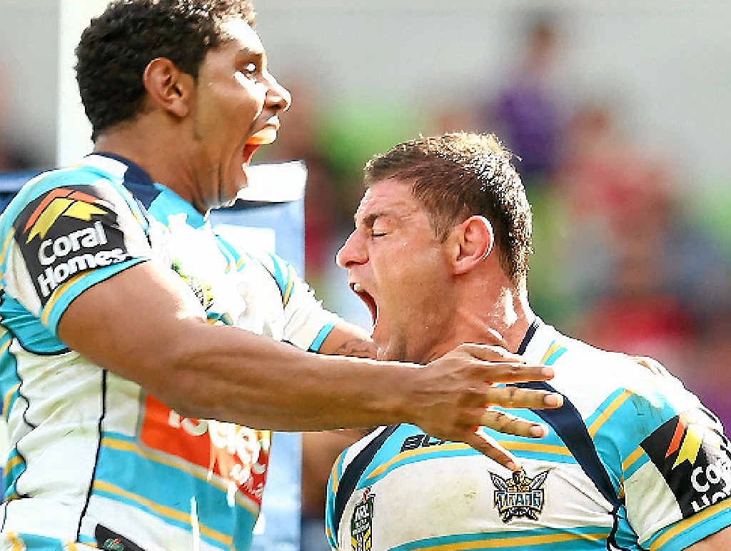 Mark Minichiello of the Titans (right) is congratulated by Albert Kelly after scoring a try against the Storm. Mark Minichiello of the Titans (right) is congratulated by Albert Kelly after scoring a try against the Storm.