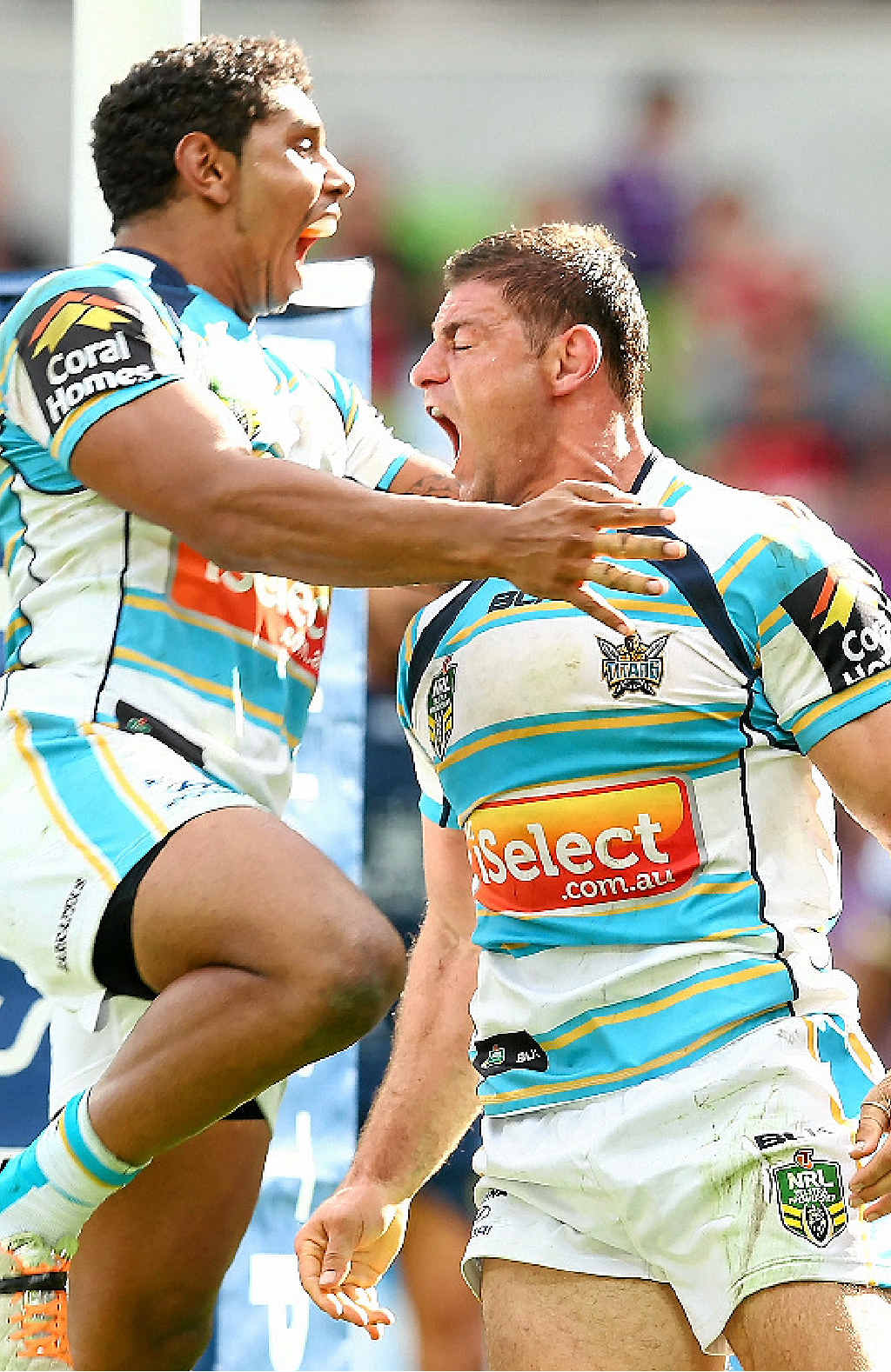Mark Minichiello of the Titans (right) is congratulated by Albert Kelly after scoring a try against the Storm. Mark Minichiello of the Titans (right) is congratulated by Albert Kelly after scoring a try against the Storm.