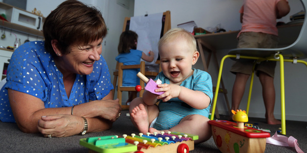 Jody Bradfield plays with Harry Prestidge, 9 months, as Isla Prestidge (back left), 4, and Oscar Prestidge, 6, occupy themselves in their playroom Jody Bradfield plays with Harry Prestidge, 9 months, as Isla Prestidge (back left), 4, and Oscar Prestidge, 6, occupy themselves in their playroom