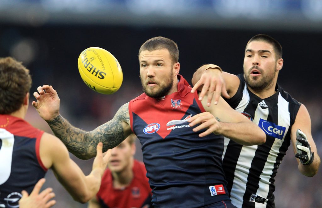Mitch Clark of Melbourne contests the ball with Chris Dawes of Collingwood Mitch Clark of Melbourne contests the ball with Chris Dawes of Collingwood