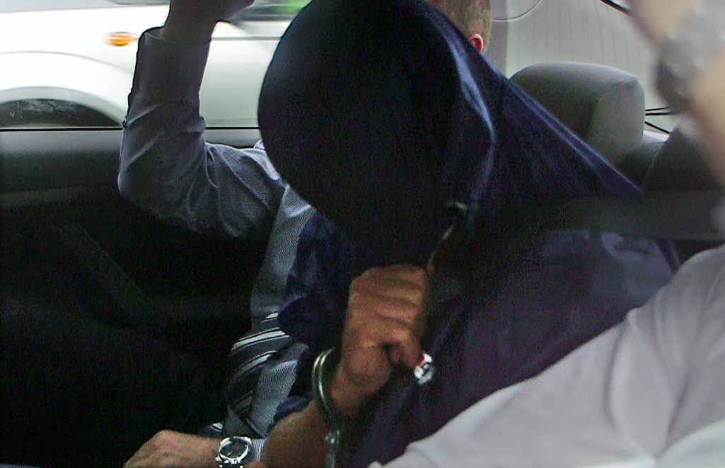 Benjamin Milward covers his face as he is taken from Coffs Harbour Police Station in April 2014. Benjamin Milward covers his face as he is taken from Coffs Harbour Police Station in April 2014.