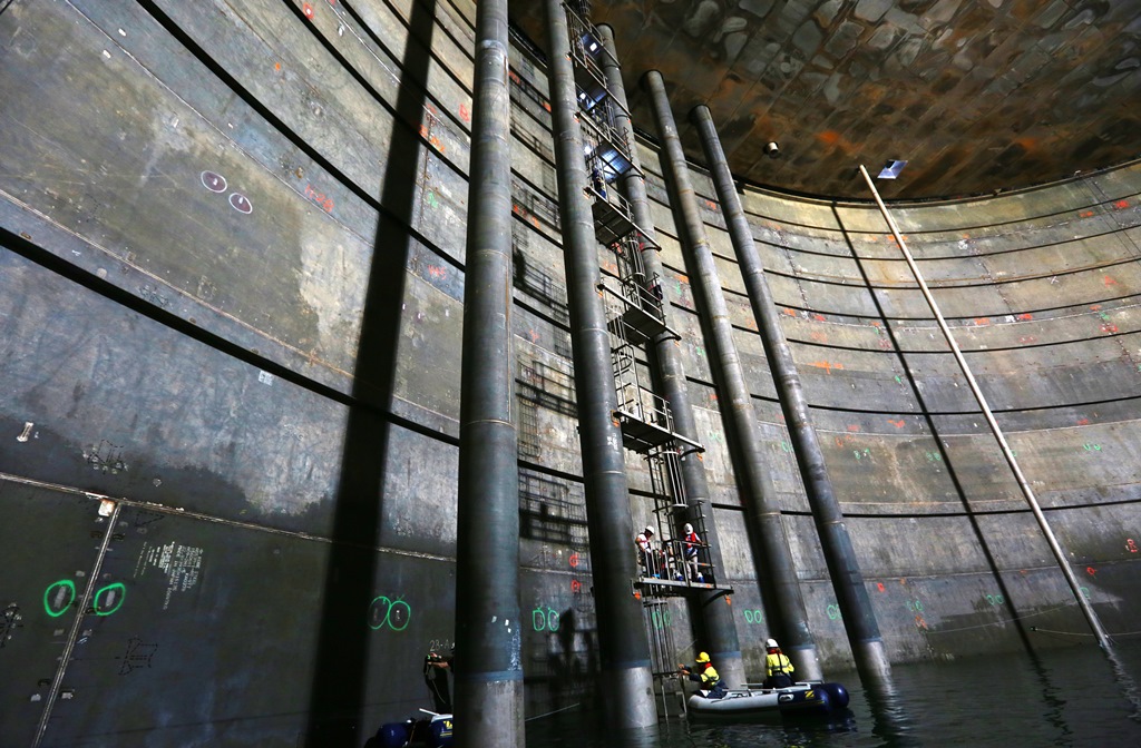 Workers carry out tests inside one of the QCLNG tanks on Curtis Island. Workers carry out tests inside one of the QCLNG tanks on Curtis Island.