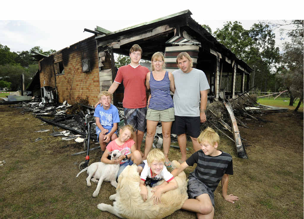 STARTING AGAIN: Michelle and Shane Douglas are holding things together for their children Hasani (standing) and front from left, Dakota, Mahalia, Izaiah and Xavier, despite losing their home in a fire on Saturday. PHOTO: JOJO NEWBY STARTING AGAIN: Michelle and Shane Douglas are holding things together for their children Hasani (standing) and front from left, Dakota, Mahalia, Izaiah and Xavier, despite losing their home in a fire on Saturday. PHOTO: JOJO NEWBY