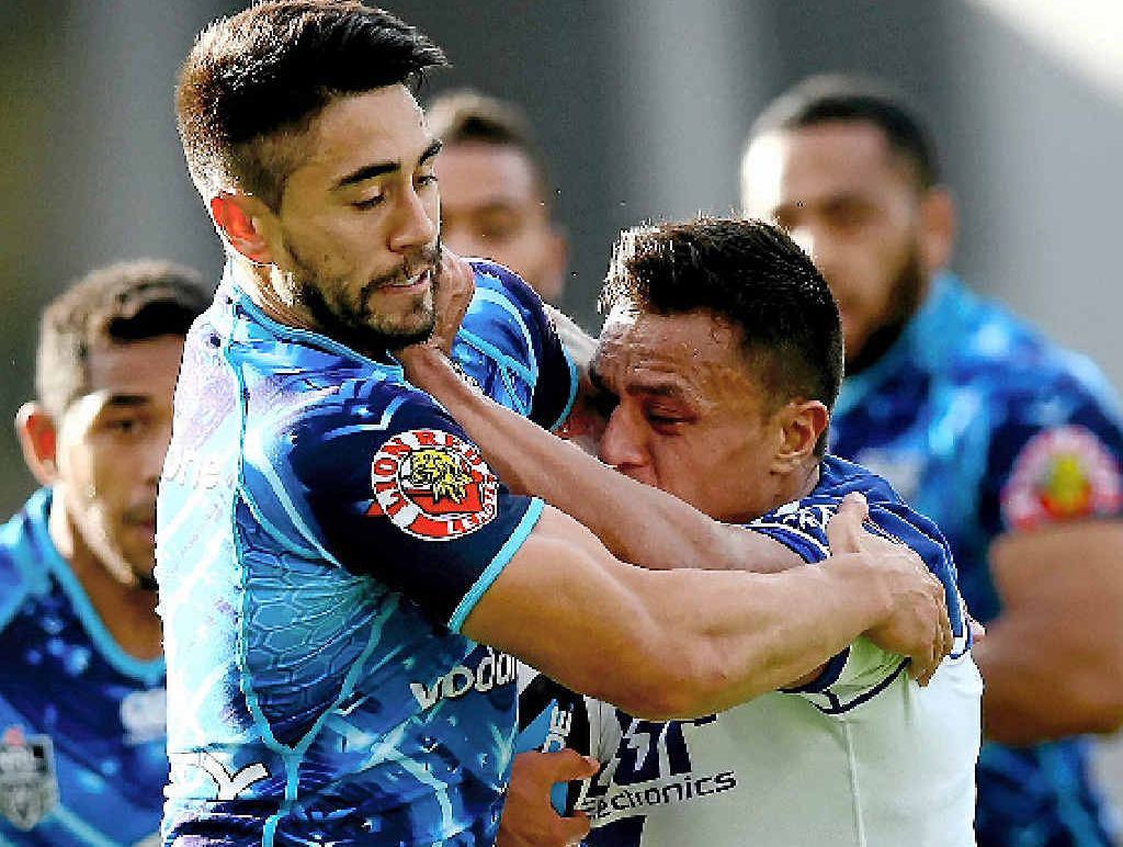 HELD UP: Sam Perrett (right) of the Bulldogs is tackled by Shaun Johnson of the Warriors in Auckland yesterday. HELD UP: Sam Perrett (right) of the Bulldogs is tackled by Shaun Johnson of the Warriors in Auckland yesterday.
