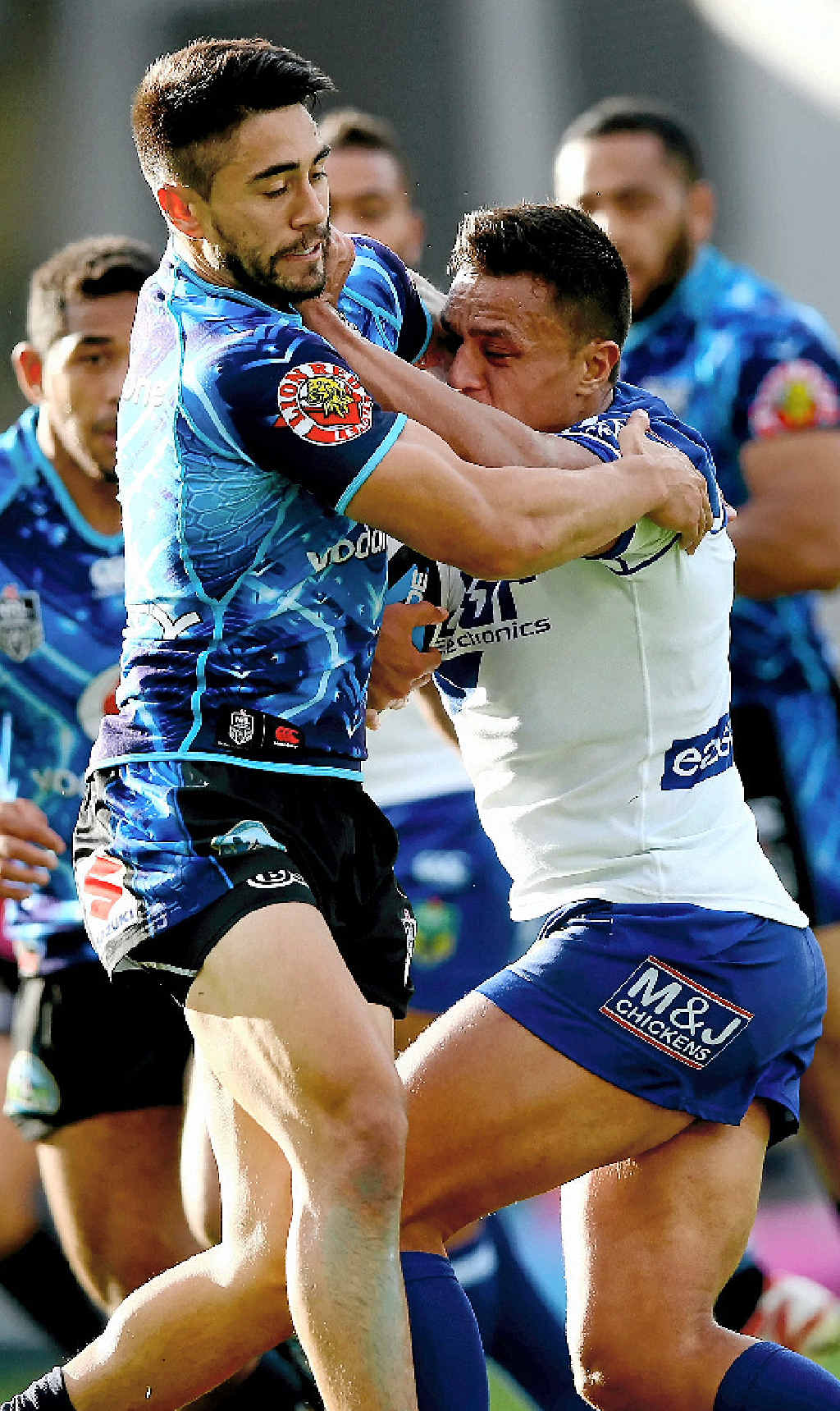 HELD UP: Sam Perrett (right) of the Bulldogs is tackled by Shaun Johnson of the Warriors in Auckland yesterday. HELD UP: Sam Perrett (right) of the Bulldogs is tackled by Shaun Johnson of the Warriors in Auckland yesterday.