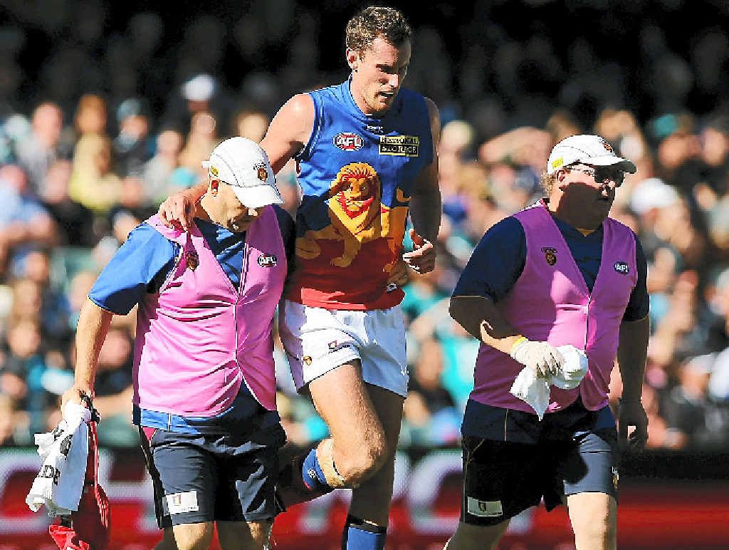 Lion Matthew Leuenberger limps from Adelaide Oval on Saturday. Lion Matthew Leuenberger limps from Adelaide Oval on Saturday.
